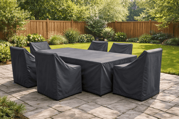 Outdoor patio dining table and chairs protected with waterproof furniture covers in a backyard garden
